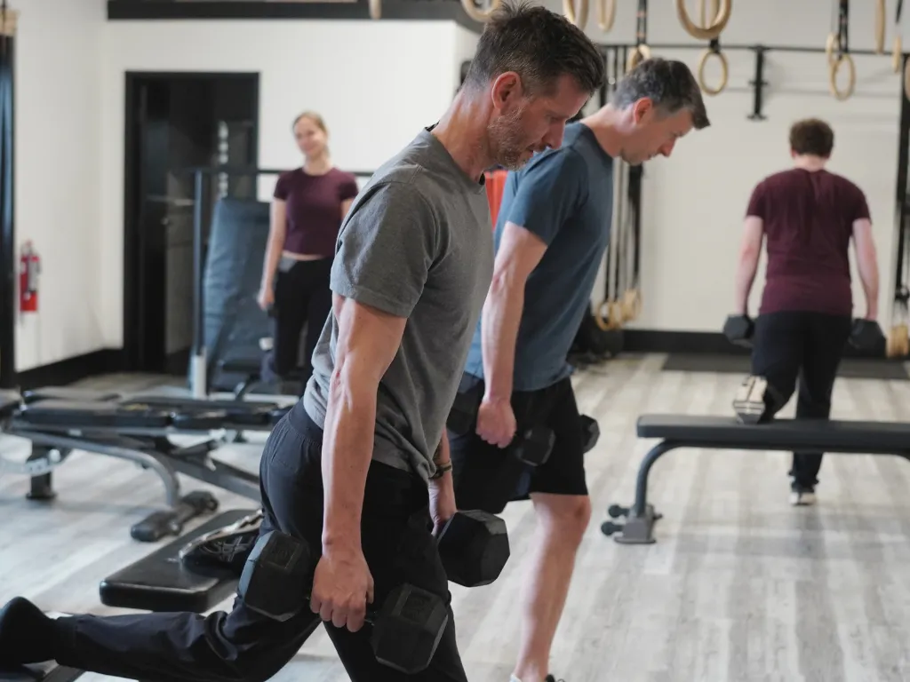 Move Strong coach assisting a client with a strength movement in Kitchener-Waterloo