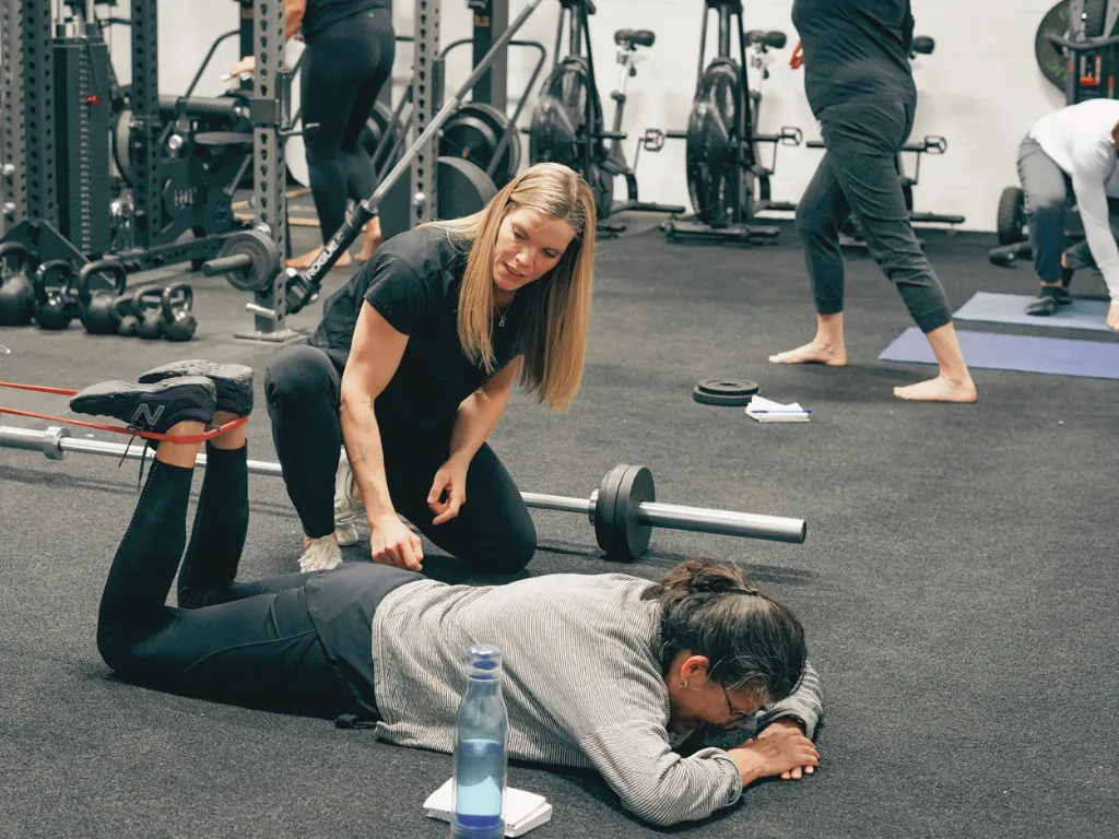 Move Strong coach correcting a member's movement and giving feedback in Kitchener-Waterloo