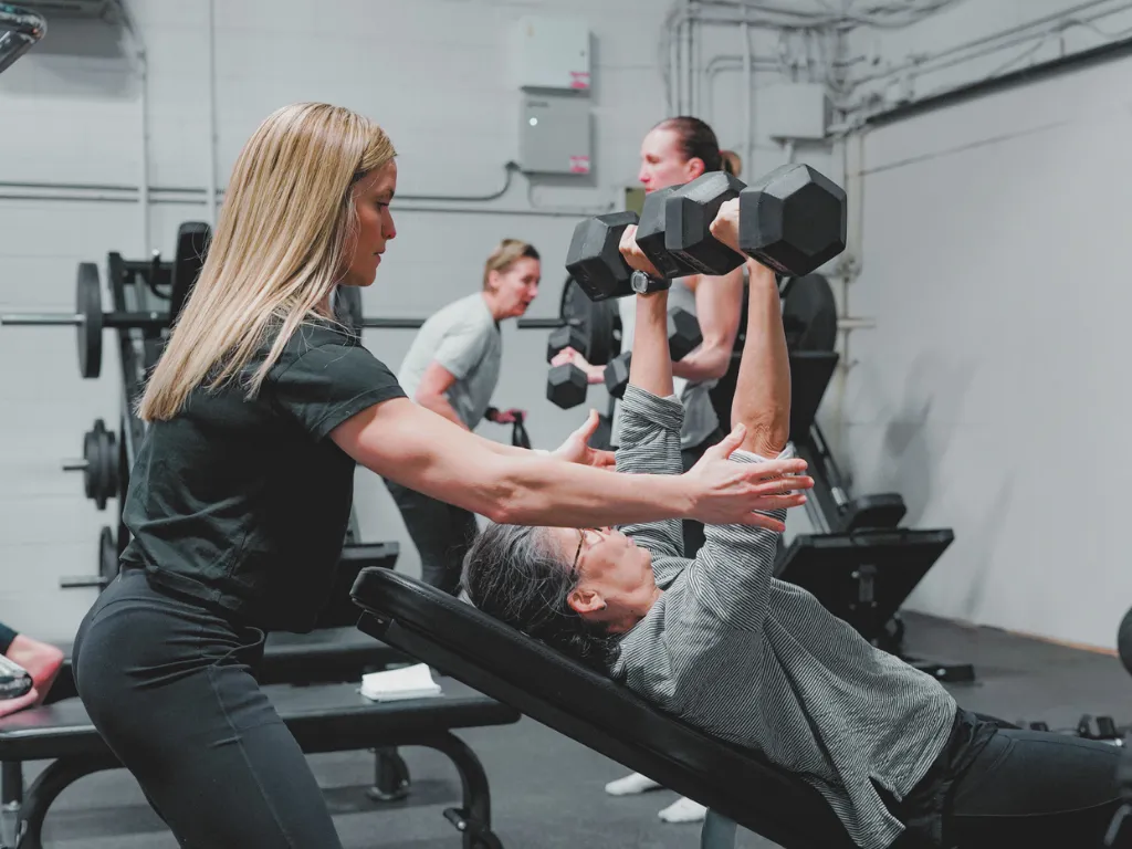 Move Strong coach working one-on-one with a member at the Kitchener-Waterloo studio