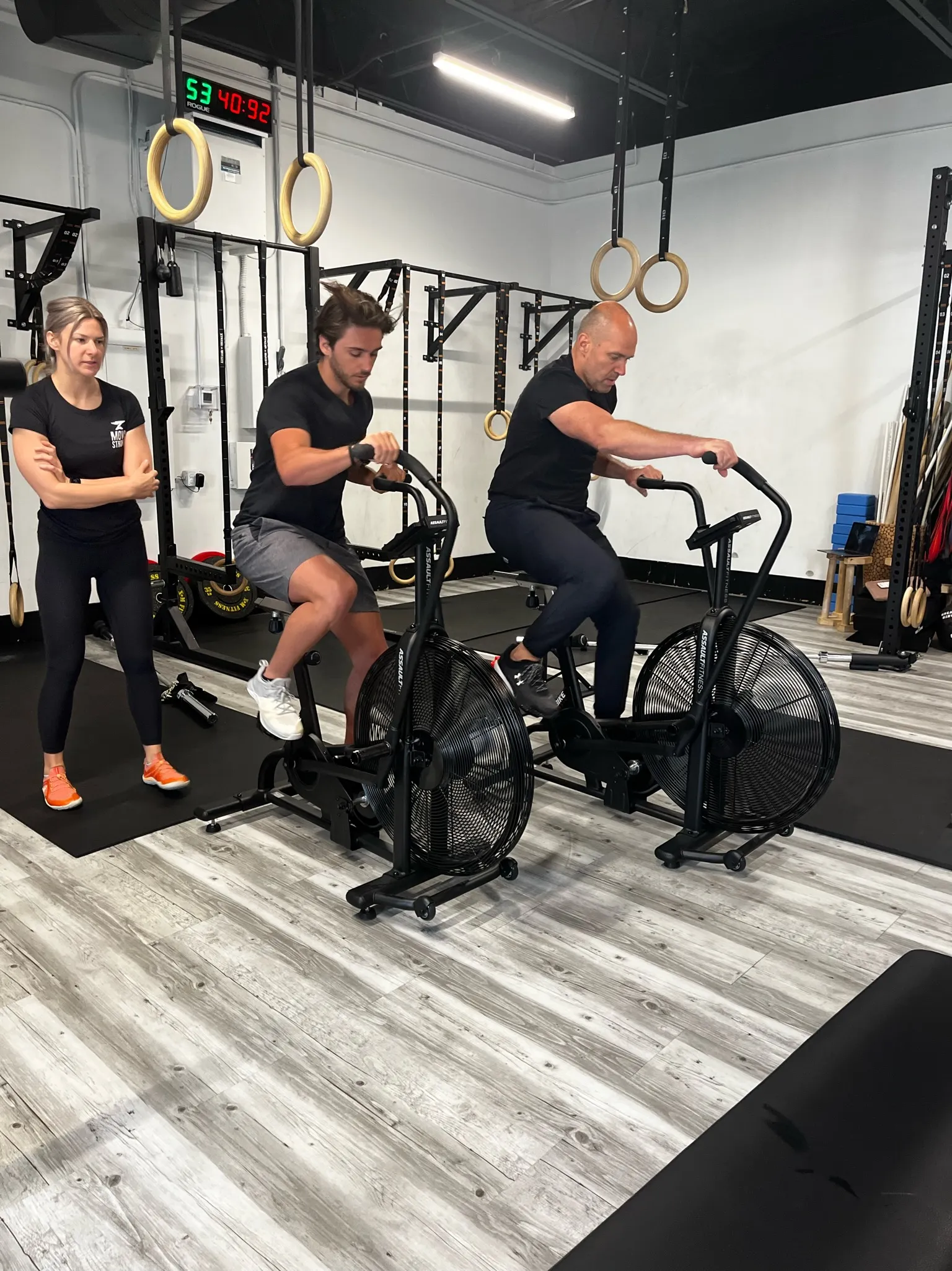 HYROX training class at Move Strong KW — members on air bikes
