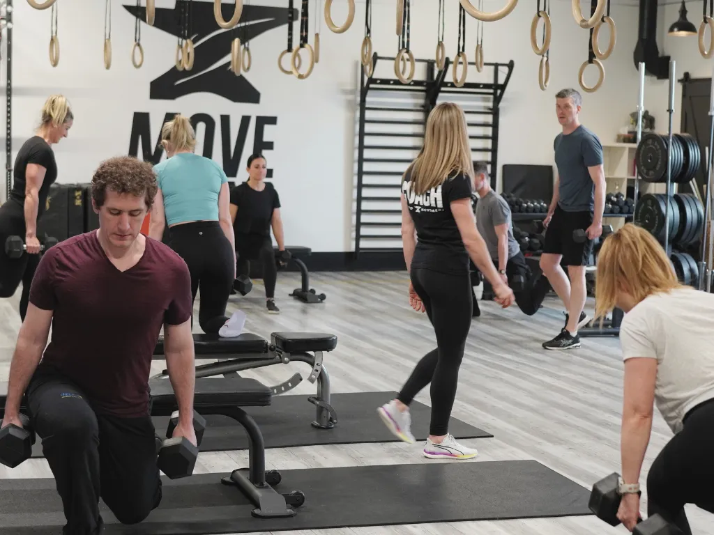 Coach assisting a Signature class at Move Strong
